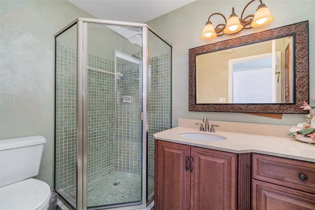 bathroom featuring vanity, toilet, and an enclosed shower