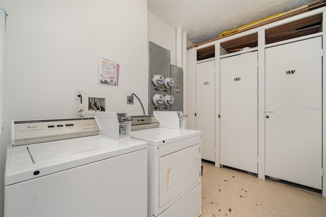 clothes washing area with a textured ceiling and washing machine and clothes dryer