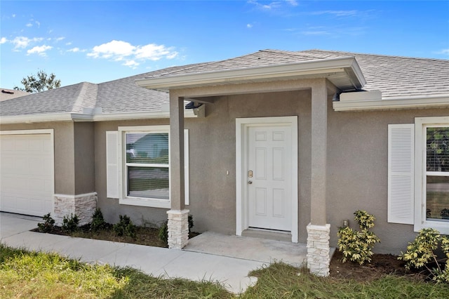 view of exterior entry with a garage