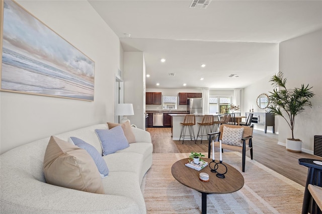 living room with light hardwood / wood-style flooring