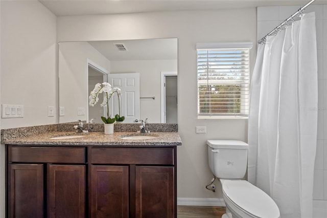 bathroom with toilet, curtained shower, hardwood / wood-style flooring, and vanity