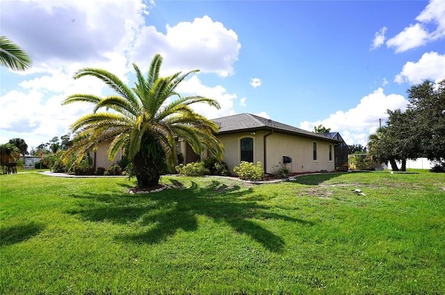 view of side of property with a lawn