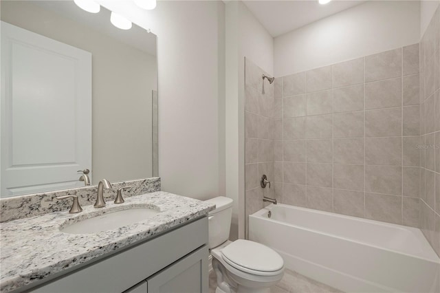 full bathroom with tiled shower / bath combo, toilet, and vanity