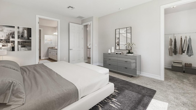 bedroom featuring carpet and ensuite bathroom