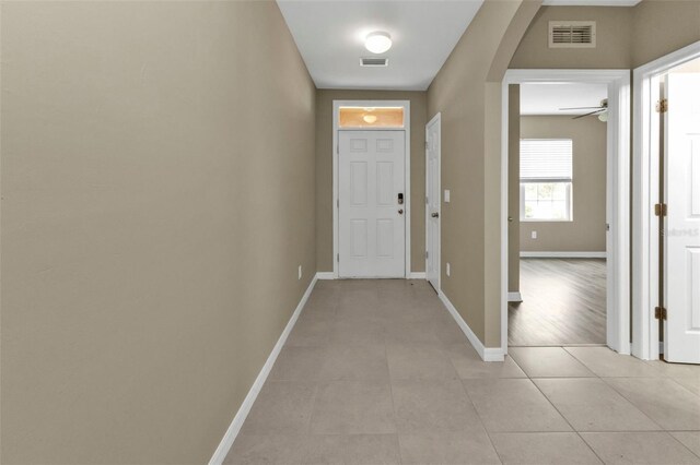 interior space with light tile patterned flooring and ceiling fan