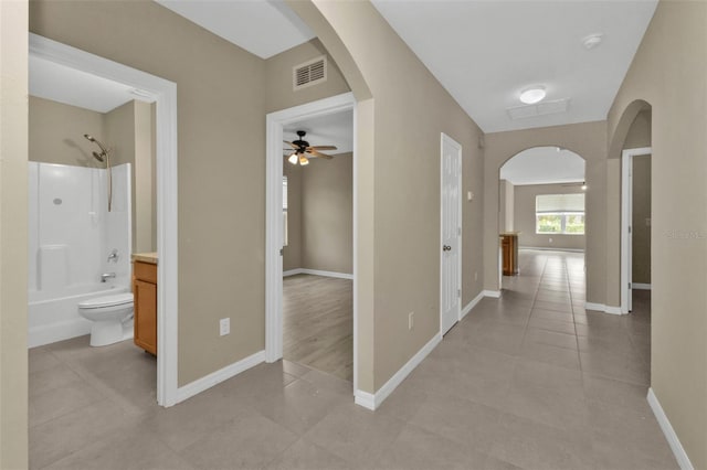 hall featuring light tile patterned floors