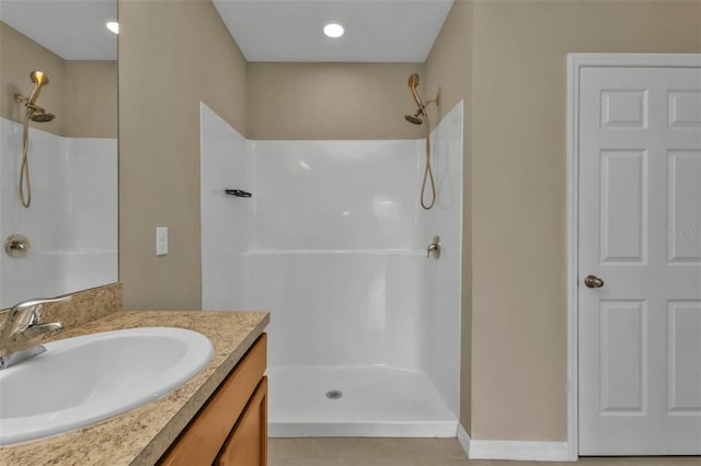 bathroom with vanity, tile patterned flooring, and walk in shower