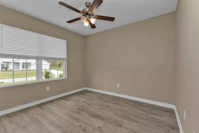 unfurnished room with light wood-type flooring and ceiling fan