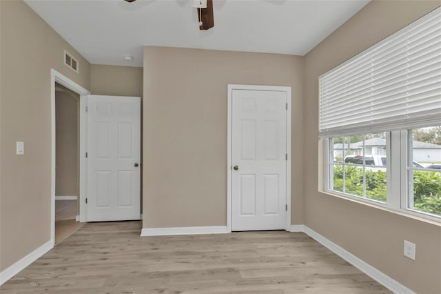 unfurnished bedroom with light hardwood / wood-style flooring and ceiling fan