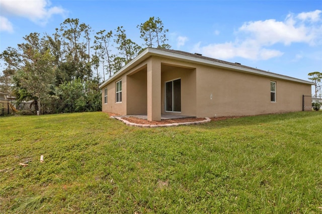 rear view of property featuring a yard