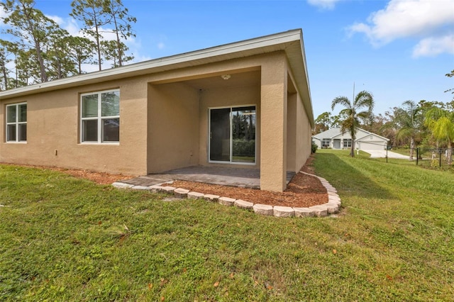 back of property featuring a yard and a patio area