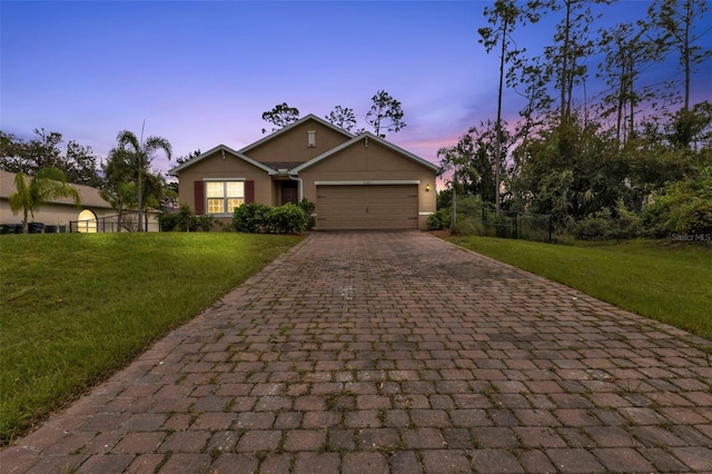 view of front facade featuring a lawn and a garage