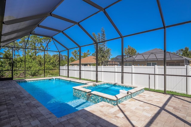 view of swimming pool with an in ground hot tub, a patio area, and a lanai