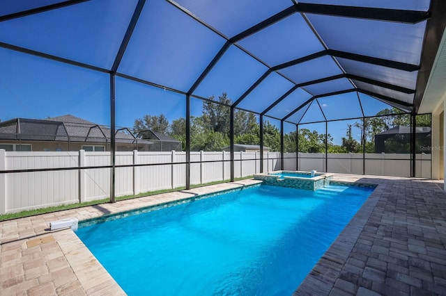 view of swimming pool with an in ground hot tub, a patio area, and glass enclosure