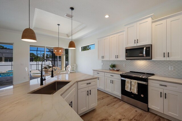 14294 Mcfarland Ave, Port Charlotte, FL 33981 - kitchen with electric stove, white cabinets, decorative backsplash, and stainless steel microwave