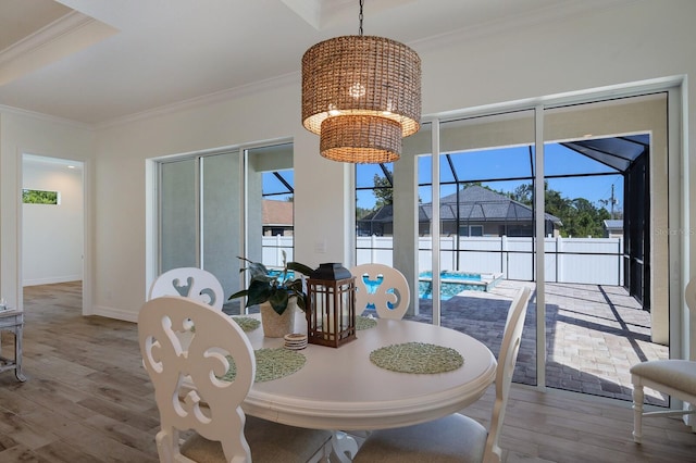 dining room featuring ornamental molding, a notable chandelier, and light wood-type flooring