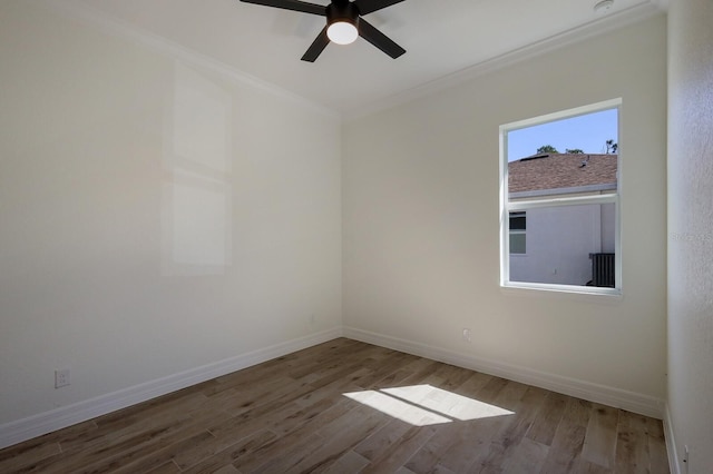 14294 Mcfarland Ave, Port Charlotte, FL 33981 - empty room featuring wood finished floors, a ceiling fan, ornamental molding, and baseboards