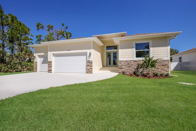 14294 Mcfarland Ave, Port Charlotte, FL 33981 - prairie-style home featuring a front yard, stone siding, french doors, and a garage