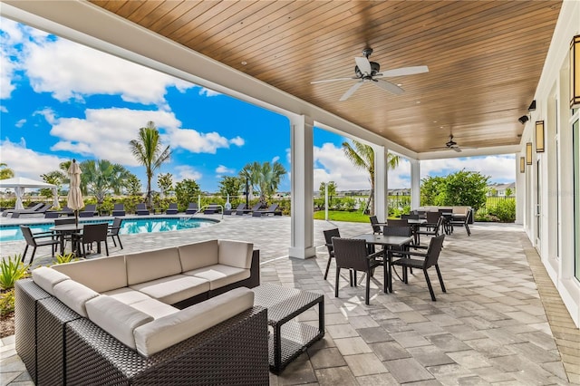 view of patio featuring a fenced in pool, ceiling fan, and an outdoor hangout area