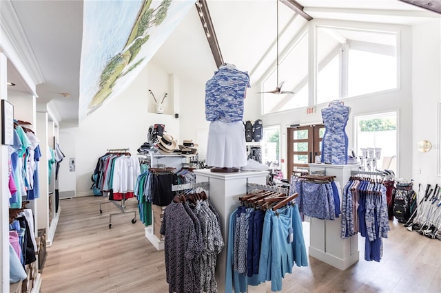 walk in closet featuring beamed ceiling, high vaulted ceiling, ceiling fan, and light hardwood / wood-style flooring