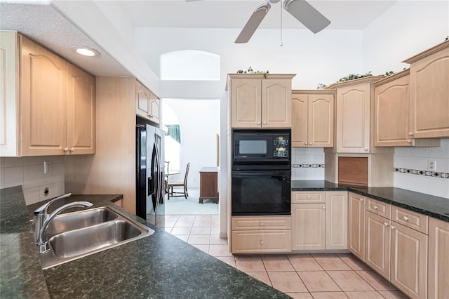 kitchen with light tile patterned floors, light brown cabinetry, sink, and black appliances