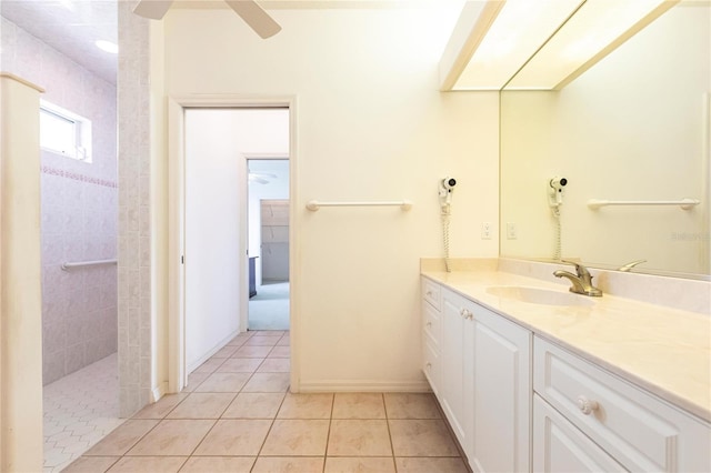 bathroom with vanity, ceiling fan, tile patterned flooring, and tiled shower