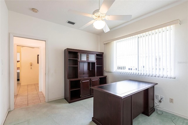 office space with light carpet and ceiling fan