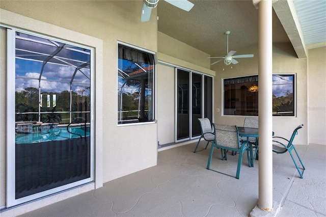 view of patio / terrace featuring ceiling fan and a lanai