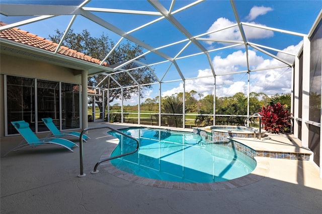 view of swimming pool featuring an in ground hot tub, a patio, and glass enclosure