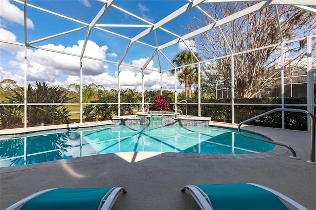 view of pool featuring a patio, glass enclosure, and an in ground hot tub