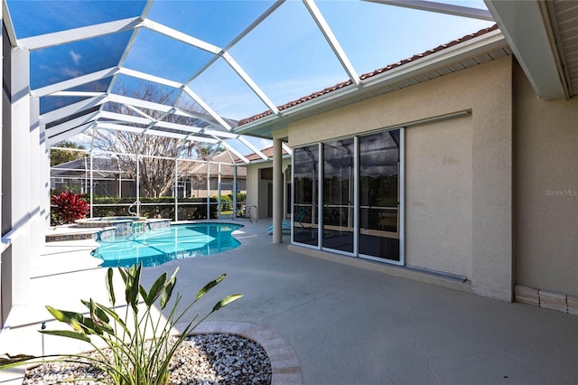 view of pool featuring a patio, a lanai, and an in ground hot tub