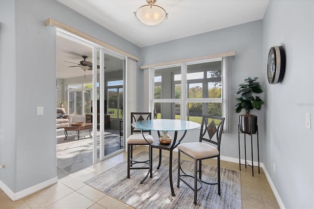 tiled dining space with ceiling fan