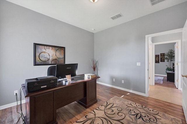 home office with dark hardwood / wood-style floors