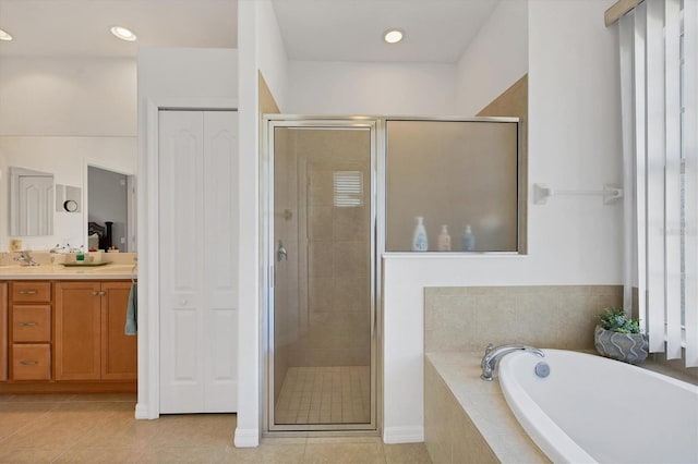 bathroom featuring vanity, tile patterned flooring, and plus walk in shower