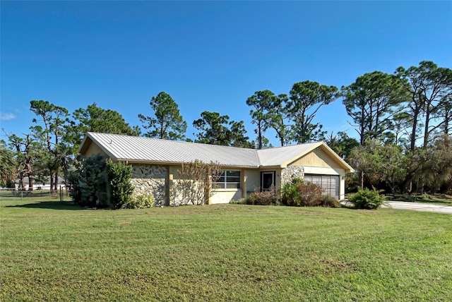 single story home featuring a front yard and a garage