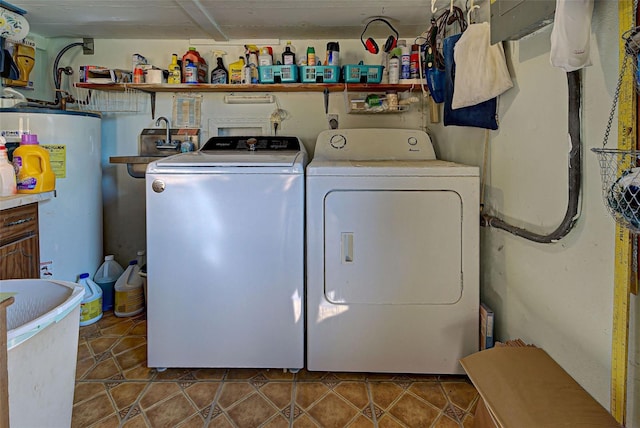 washroom featuring washer and dryer, tile patterned floors, and gas water heater