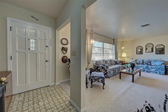 foyer with light colored carpet