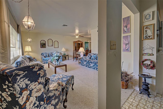 carpeted living room with ceiling fan