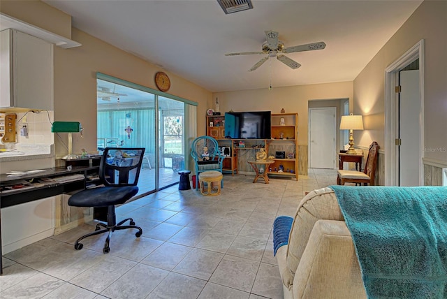 tiled living room with ceiling fan