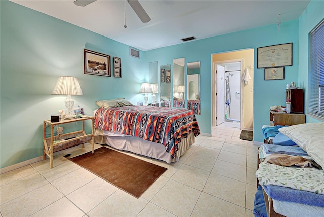 tiled bedroom with ceiling fan and ensuite bath