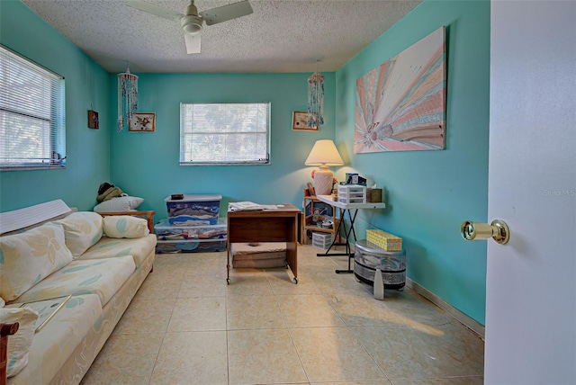 interior space featuring a textured ceiling and ceiling fan