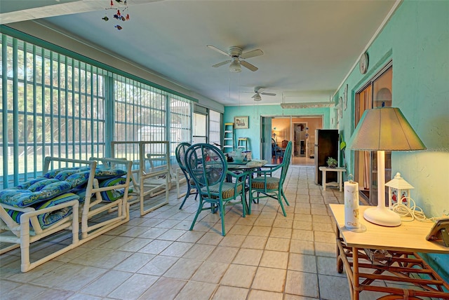 sunroom / solarium featuring ceiling fan