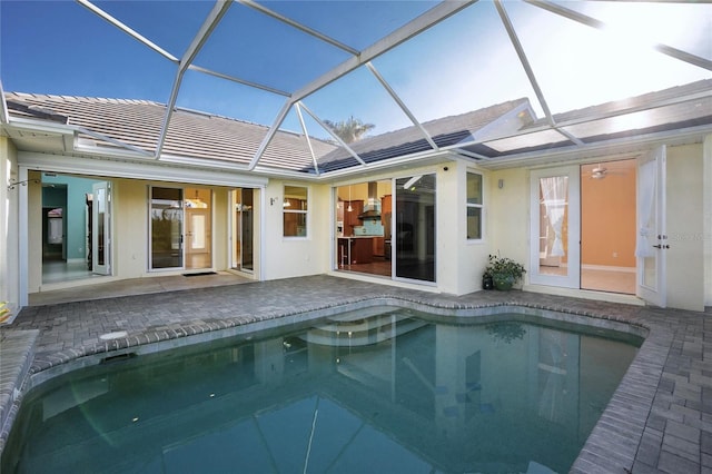 rear view of property with a patio and glass enclosure