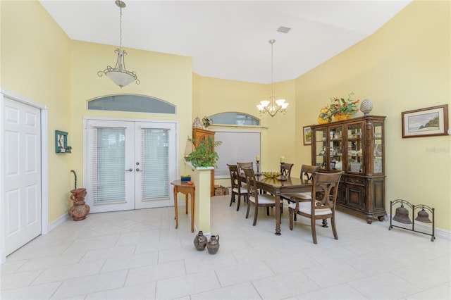 dining space featuring a notable chandelier, light tile patterned floors, a high ceiling, and french doors