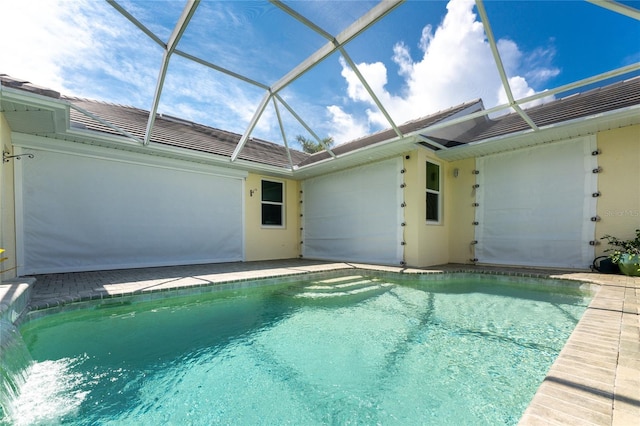 view of pool with glass enclosure