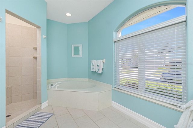 bathroom with tile patterned flooring, a healthy amount of sunlight, and plus walk in shower