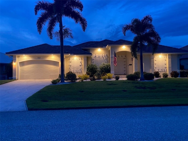 view of front of home featuring a front yard and a garage