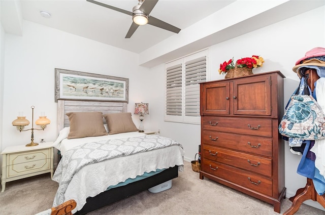 bedroom with light carpet and ceiling fan