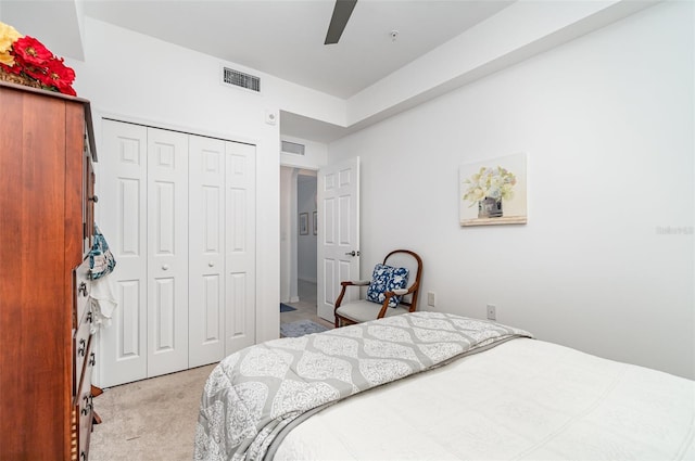 carpeted bedroom featuring a closet and ceiling fan