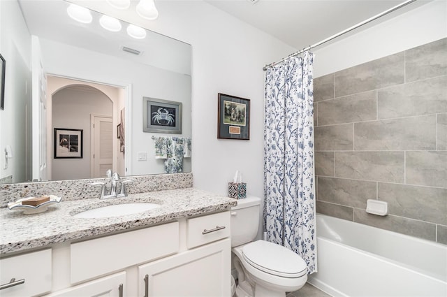 full bathroom with vanity, toilet, and shower / tub combo with curtain